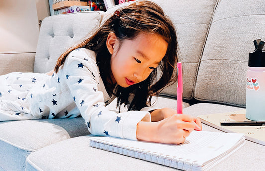 Young girl writing in a journal