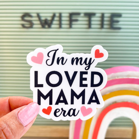 In my loved mama era sticker with black font and hearts
