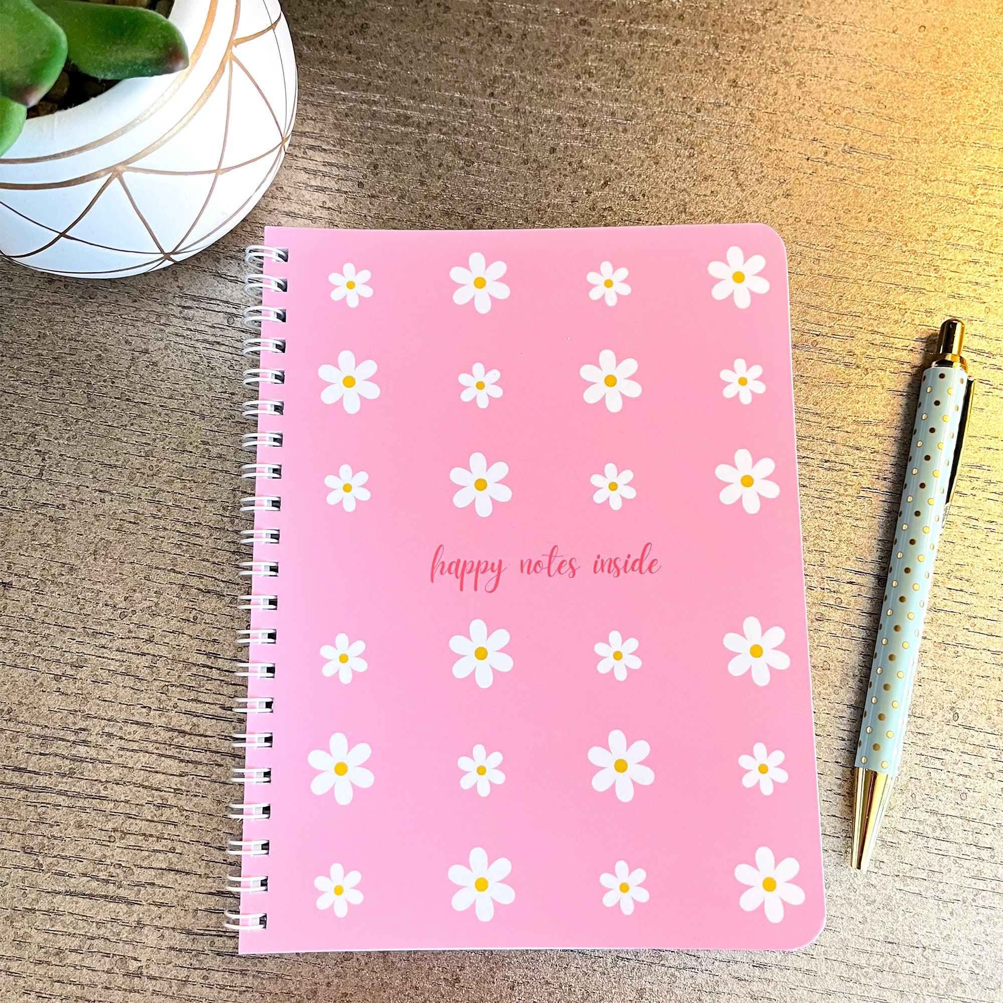 Pink daisy notebook flat lay