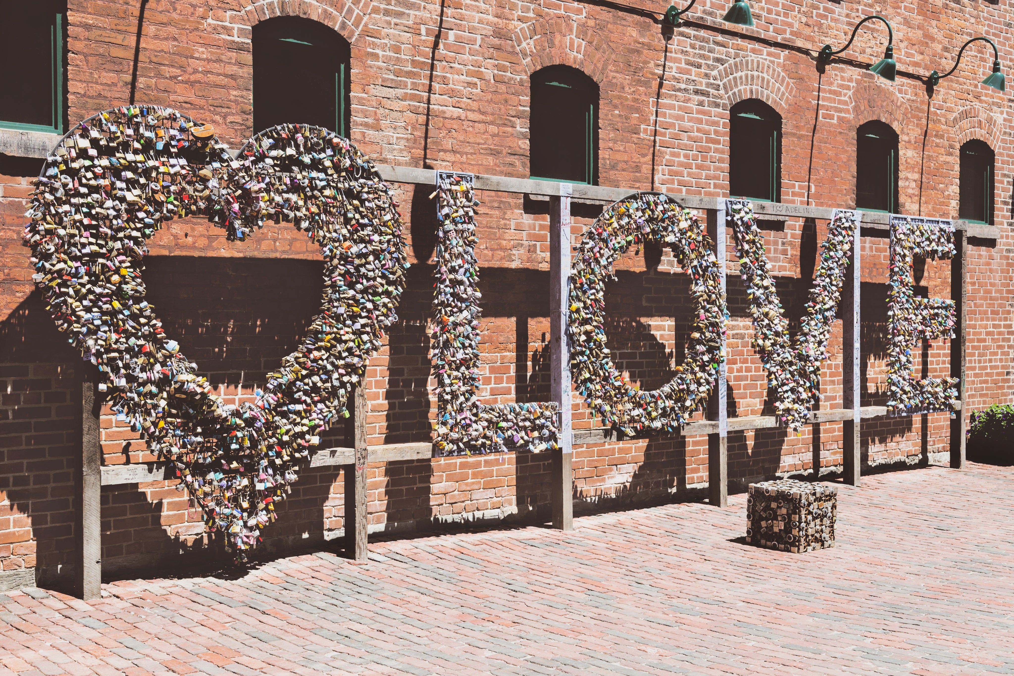 Sign saying LOVE set against a brick building