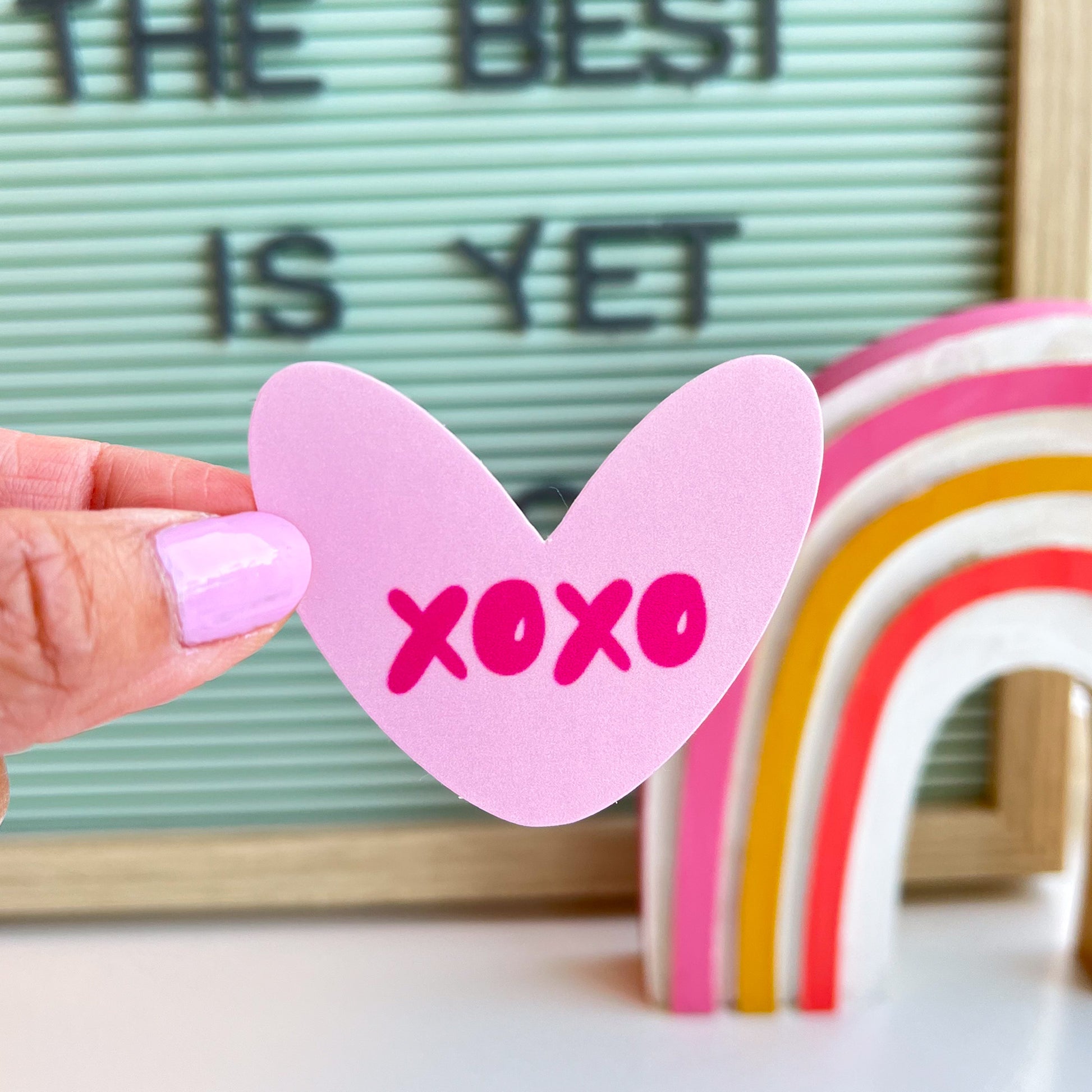 XOXO heart sticker in hand. Perfect for Valentine's Day and classroom gift exchanges.