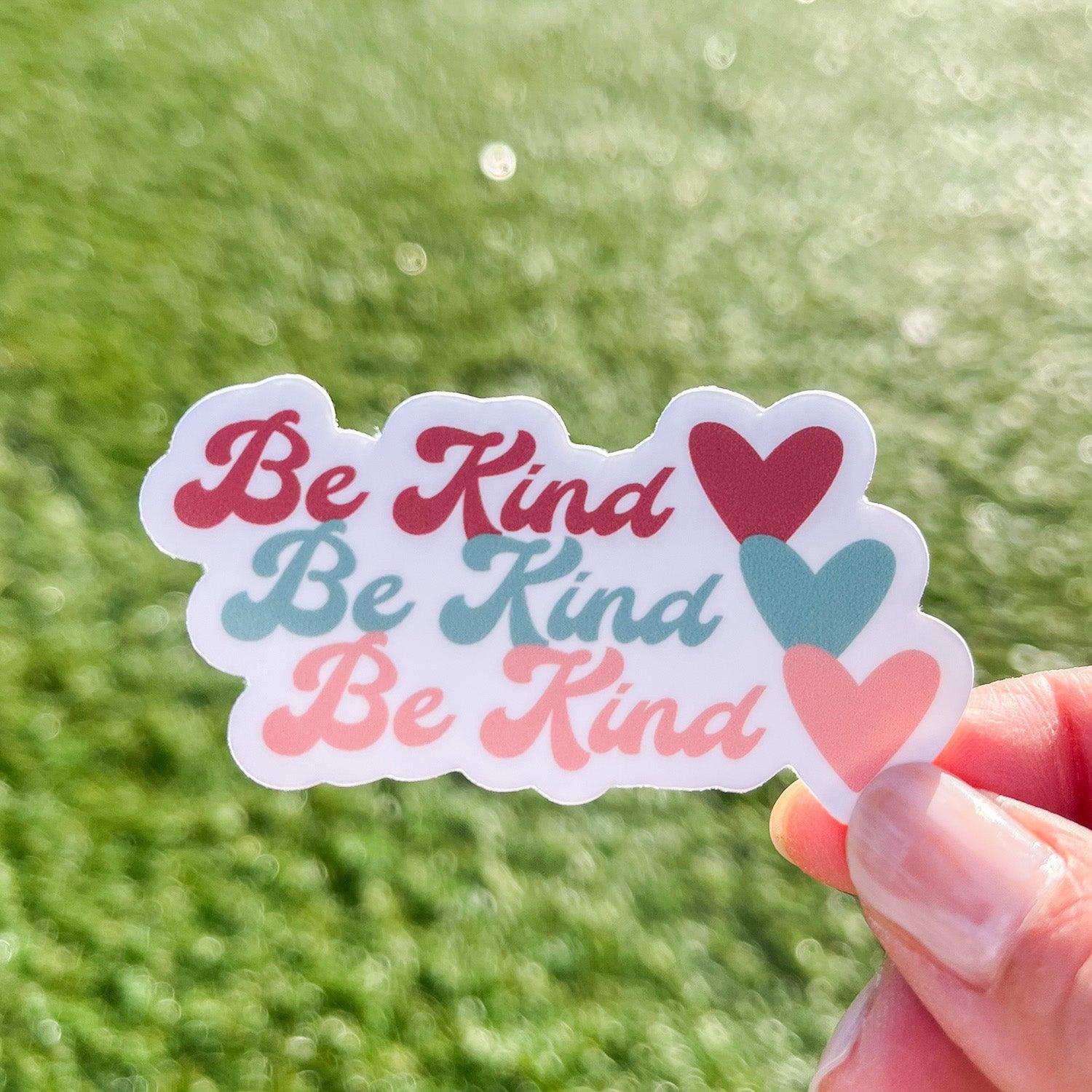 Be Kind sticker with grass and sunshine in the background