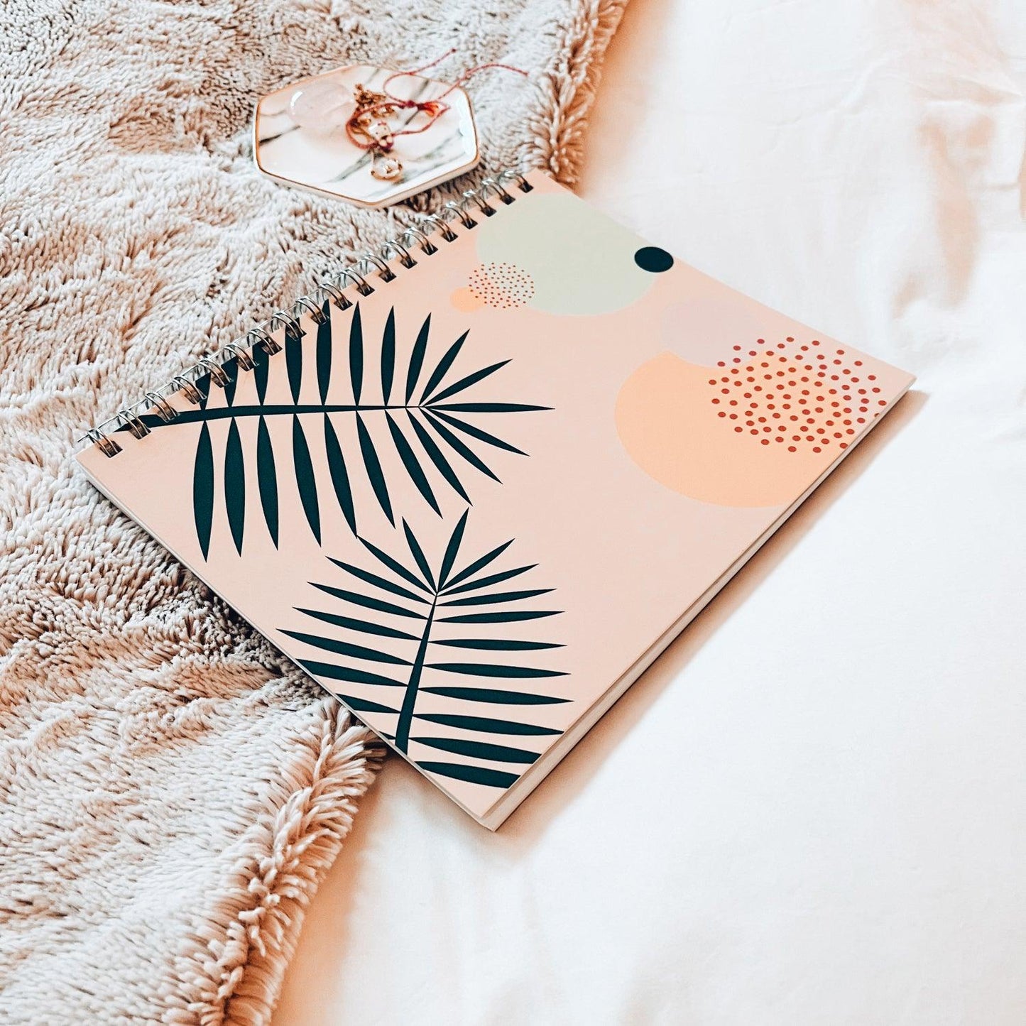 Cool and calm journal flat lay on bed