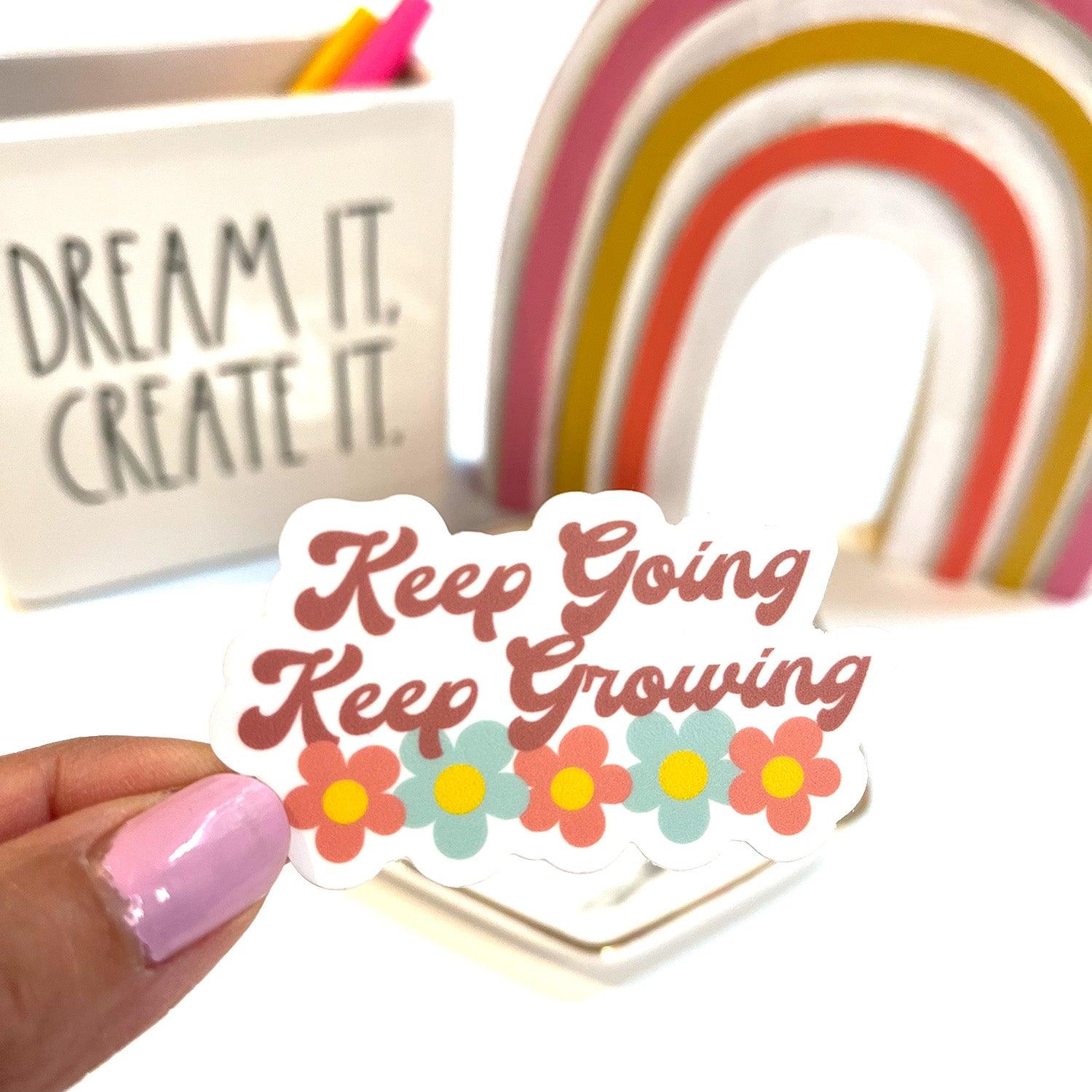 Keep going keep growing sticker shown indoors with rainbow background