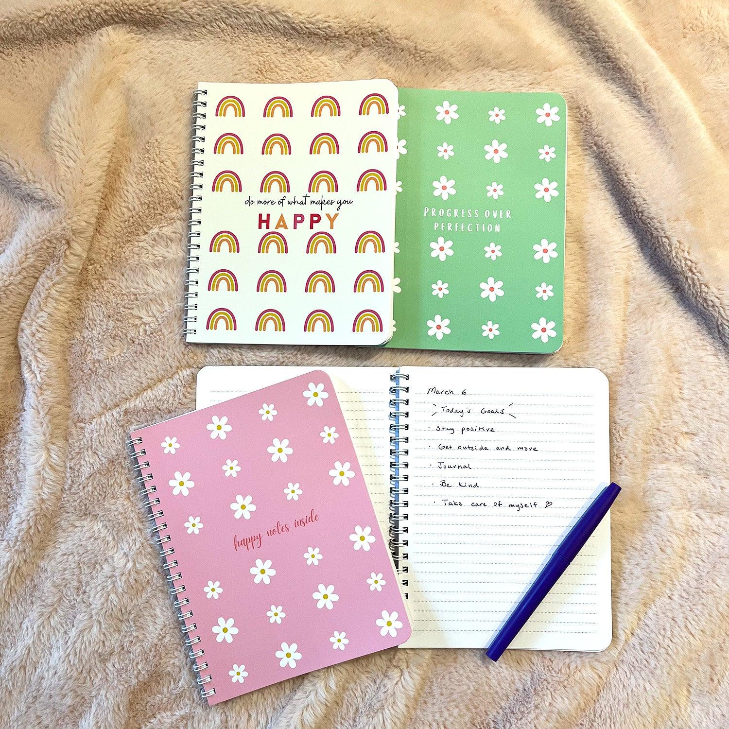 Flat lay of all notebooks with writing example