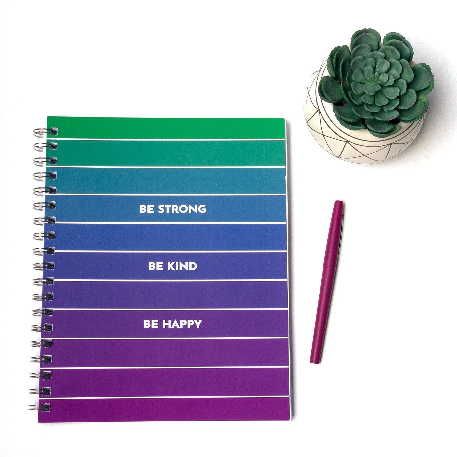 Be Strong Be Kind Be Happy Journal flat lay with small cactus and pen in the background